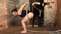 Crucified busty redhead gets caned
