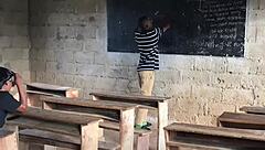 class teacher explains biology lesson to student with care
