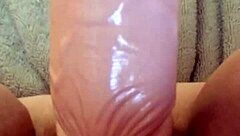 She masturbates with dildo for her man.