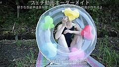 a woman carefully inflates a float with air